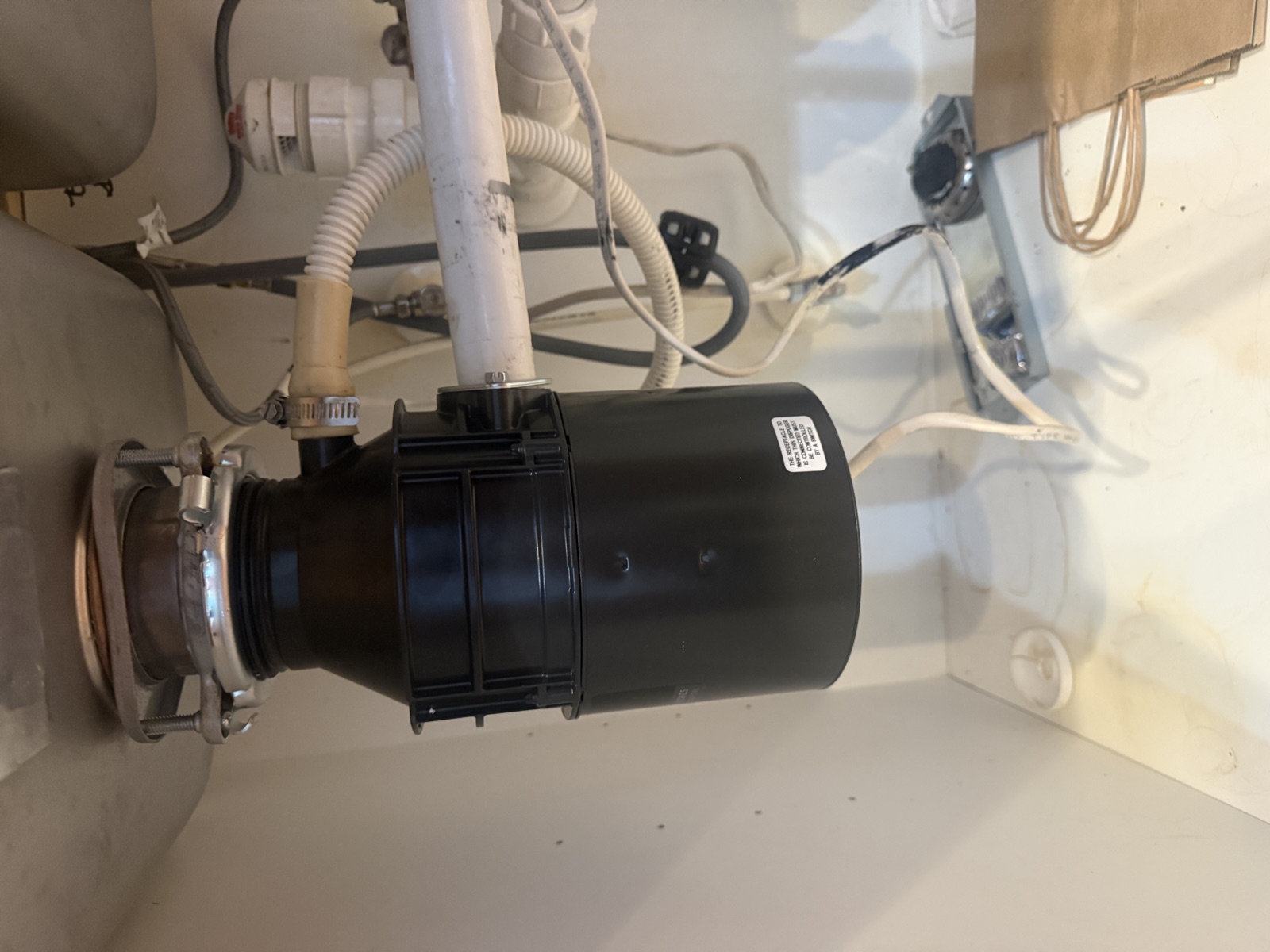 New garbage disposal installed under a kitchen sink by FixCraft VP in Charlotte NC