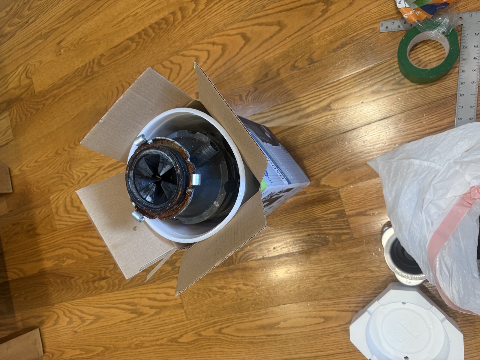 Old garbage disposal removed during a replacement service in Charlotte NC
