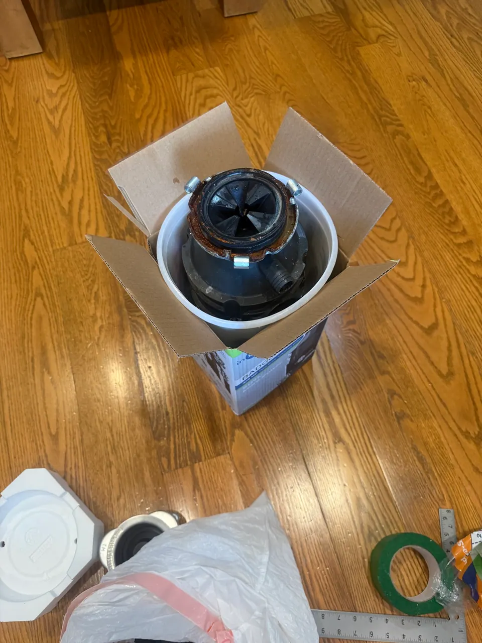 Old garbage disposal removed during a replacement service in Charlotte NC
