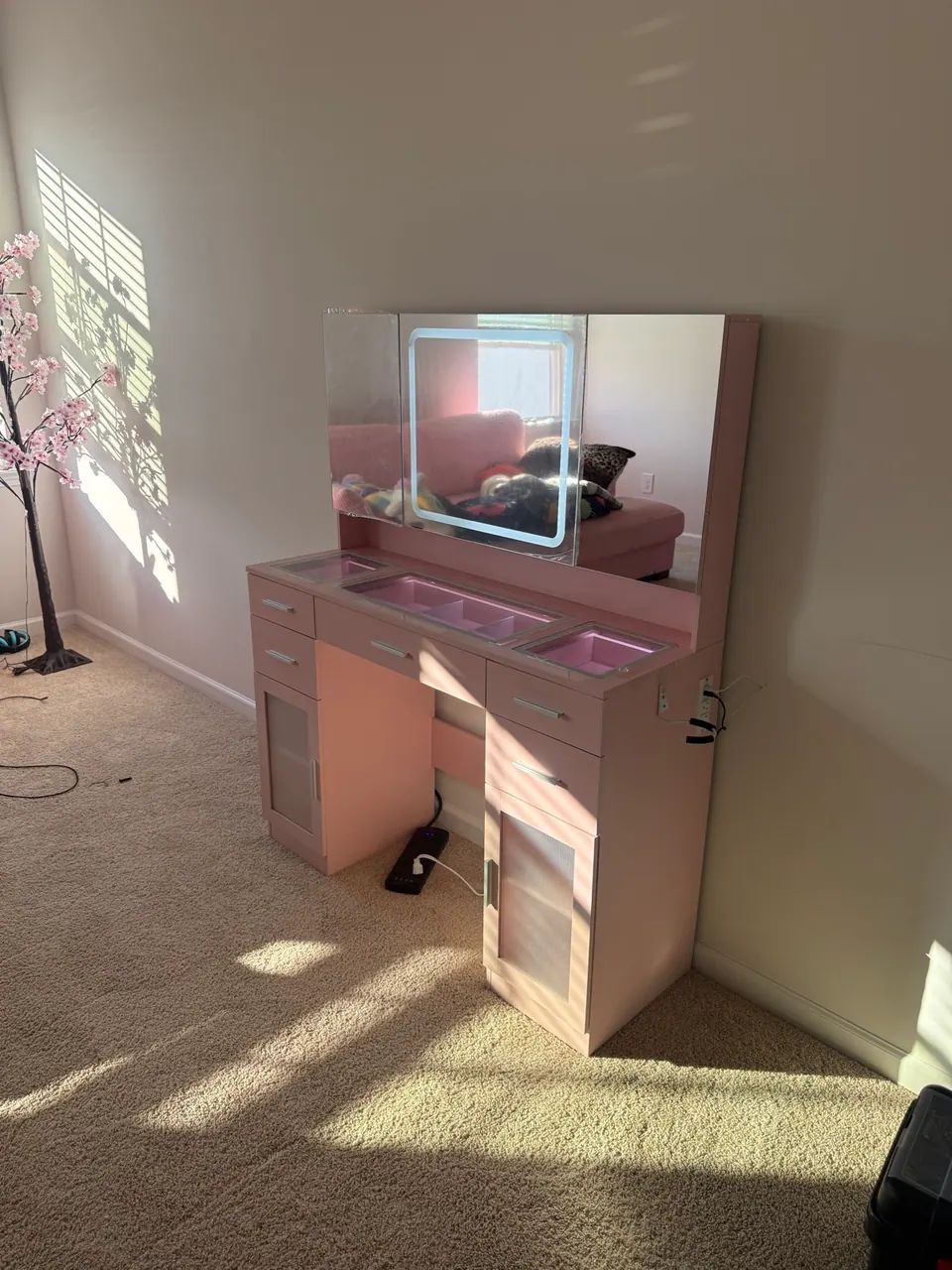 Pink vanity with LED tri-fold mirror assembled for a kid bedroom in Charlotte