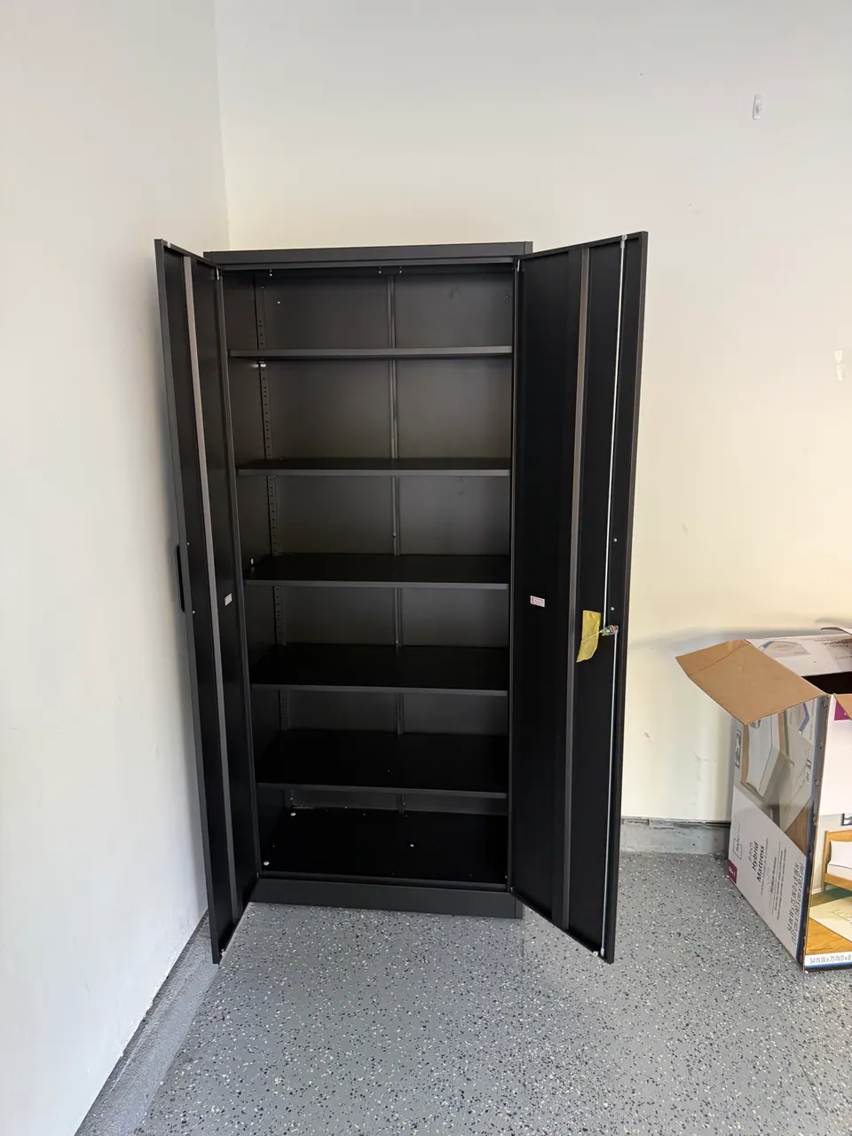 Open view of heavy-duty steel storage cabinet with shelves