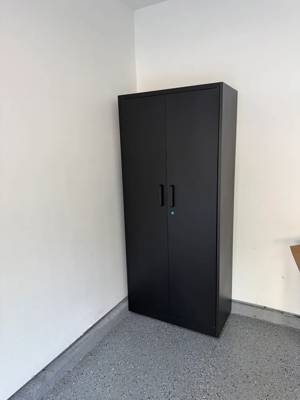 Heavy-duty black steel storage cabinet assembled by FixCraft VP