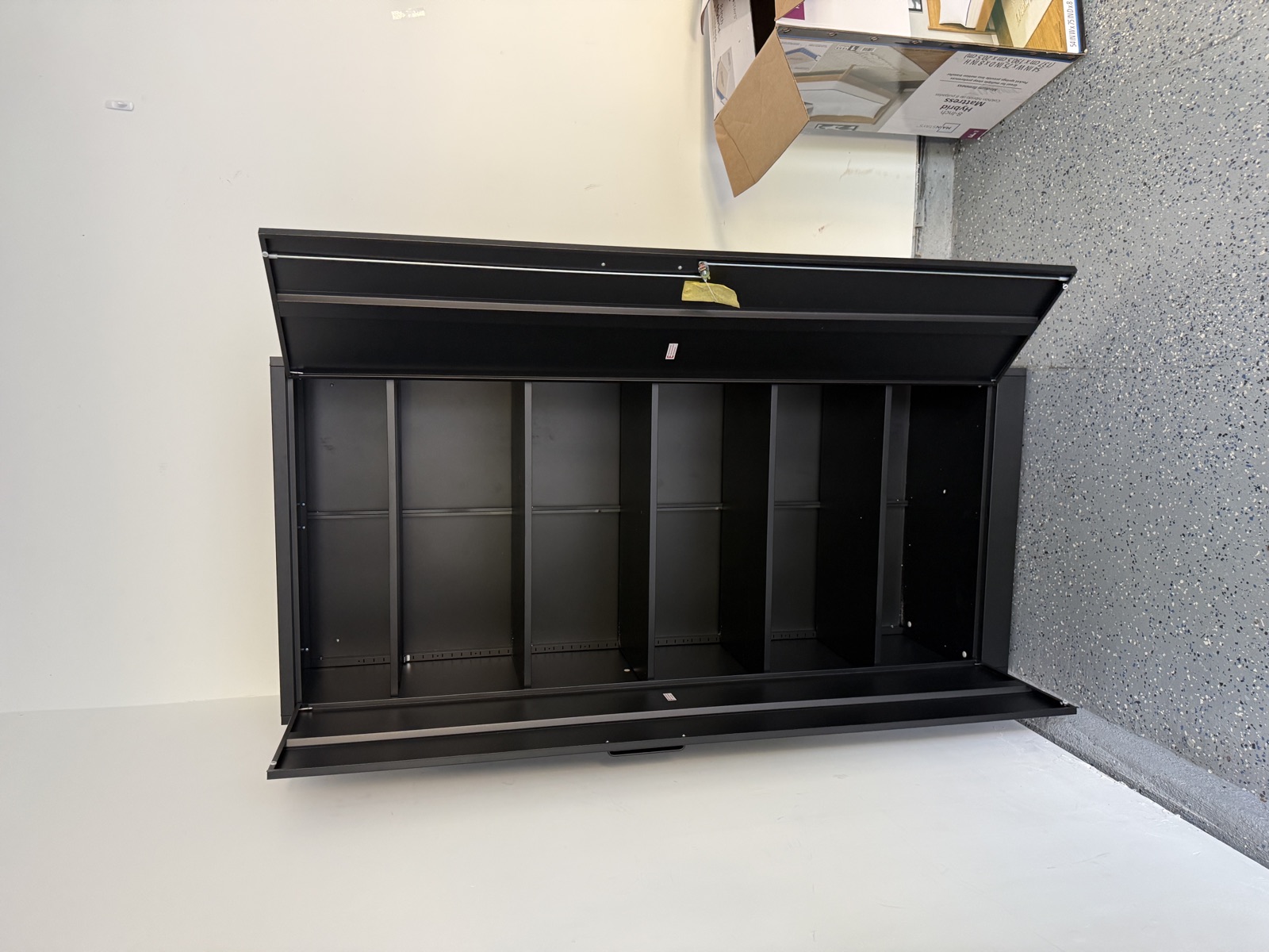 Open view of heavy-duty steel storage cabinet with shelves
